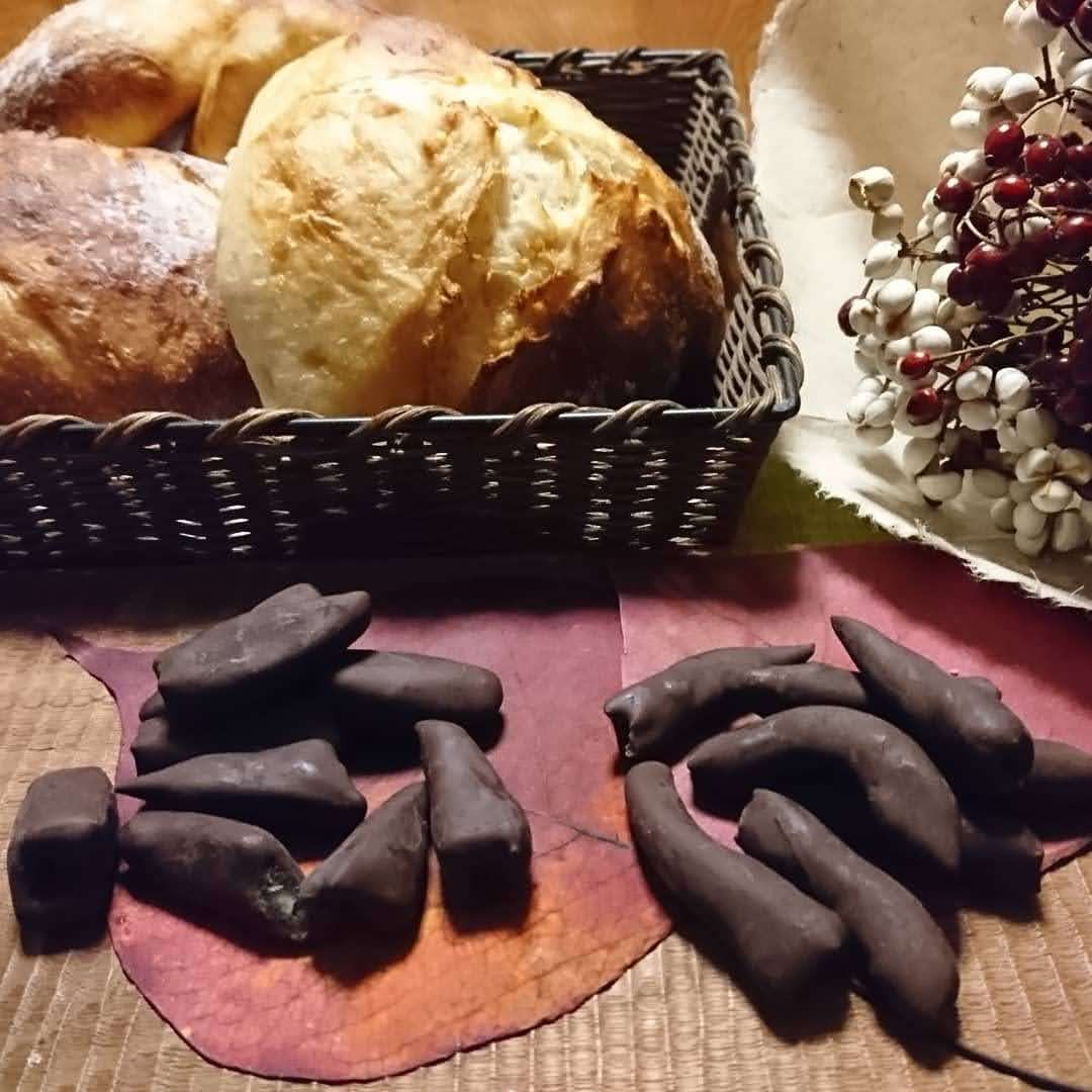 手作りピールチョコとパンが籠と木盆の上に並んでいます